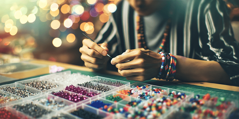 A kandi crafter creating a personalized bracelet